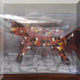 D121. Painted cow figurine.